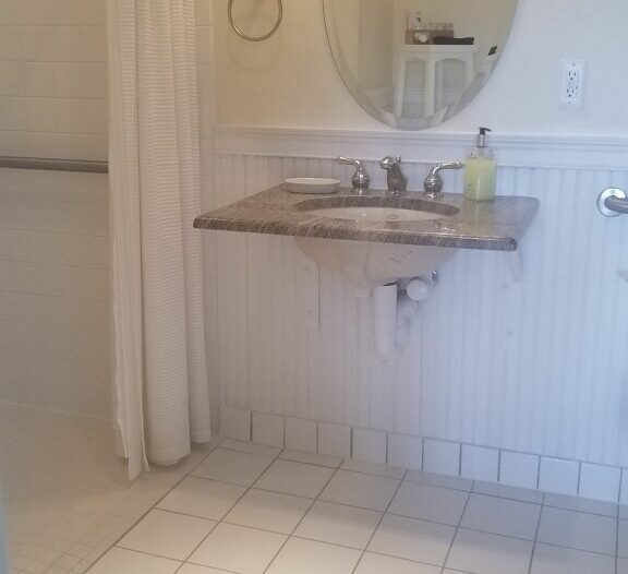 Sink allows wheelchair movement underneath.